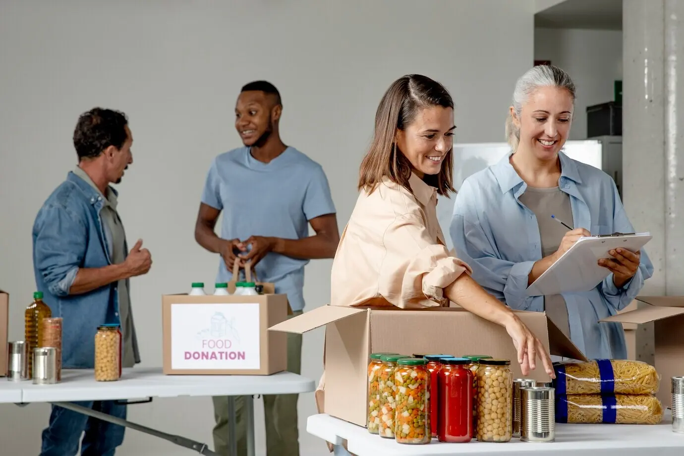 Medium shot of smiling people with food donations