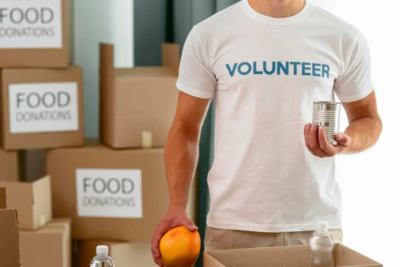 A male volunteer preparing food to give to a charity.